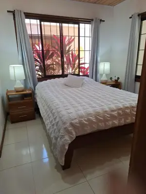 a bedroom with a large bed and a window at Apartamento LAMBERT in Playa Pelada