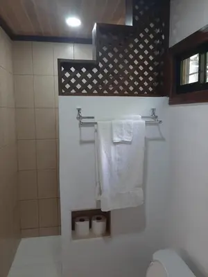 a bathroom with a toilet and towels on a wall at Apartamento LAMBERT in Playa Pelada