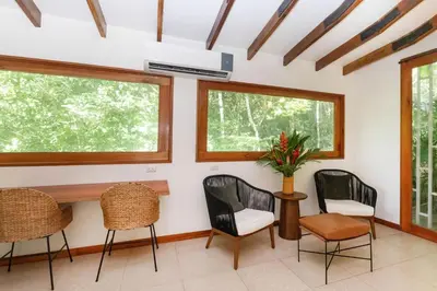 a room with three chairs and a table and windows at Tropical Casa Ventanas with private pool in MA in Quepos