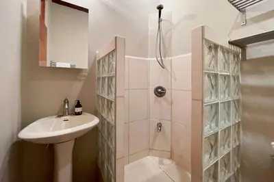 a bathroom with a shower and a sink at Tropical Casa Ventanas with private pool in MA in Quepos