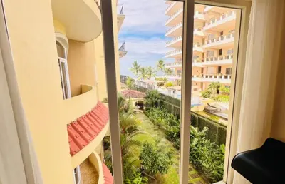 a balcony with a view of a building at Acqua Residences 5 Star in Jacó