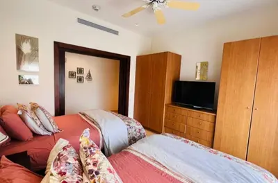 a bedroom with a bed and a flat screen tv at Acqua Residences 5 Star in Jacó