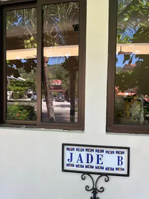 a sign on the side of a building with windows at The Beach House Ground Floor Condo in Coco
