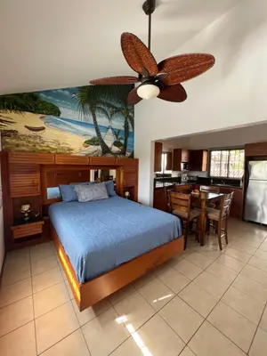 a bedroom with a bed and a ceiling fan at Tropical Beach Second Floor Studio with Hill view in Coco