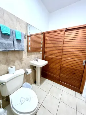 a bathroom with a toilet and a sink at Tropical Beach Second Floor Studio with Hill view in Coco