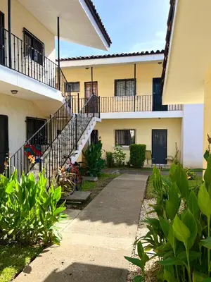 a building with stairs and plants in front of it at Tropical Beach Second Floor Studio with Hill view in Coco