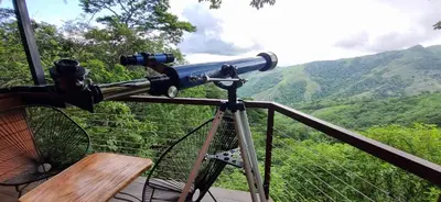a telescope on a balcony looking at the mountains at Finca Sunset Monteverde in Monteverde Costa Rica