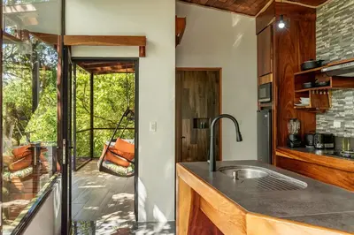 a kitchen with a sink and a view of a patio at Finca Sunset Monteverde in Monteverde Costa Rica