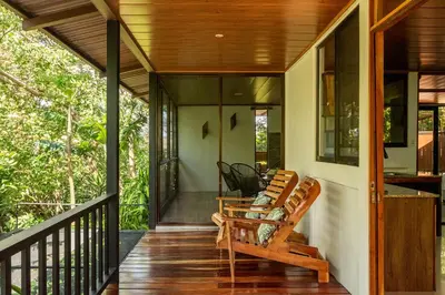a screened porch with rocking chairs on a house at Finca Sunset Monteverde in Monteverde Costa Rica