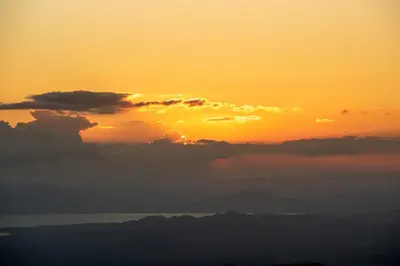 a sunset over the ocean with clouds in the sky at Finca Sunset Monteverde in Monteverde Costa Rica