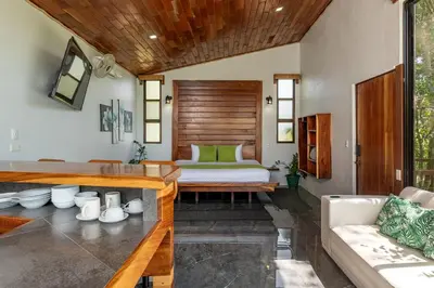 a living room with a bed and a couch at Finca Sunset Monteverde in Monteverde Costa Rica