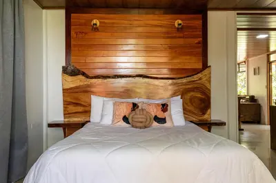a person laying on a bed in a bedroom at Finca Sunset Monteverde in Monteverde Costa Rica