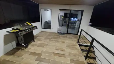 a room with a staircase and a room with a floor at Casas Doña Juanita in Jacó