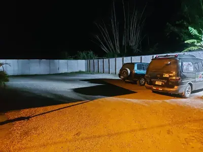 two cars parked in a parking lot at night at Casas Doña Juanita in Jacó