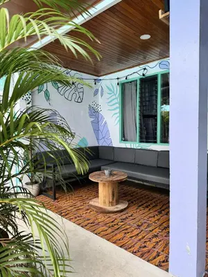 a patio with a table in the middle of a building at Pura Vibra Hostel in Fortuna