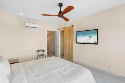 a bedroom with a bed and a ceiling fan at Stylish Villa with Brand-New Furniture, Panoramic Ocean Views, and Infinity Swimming Pool & Hot Tub in Potrero