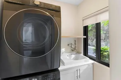 a microwave oven in a kitchen with a sink at Stylish Villa with Brand-New Furniture, Panoramic Ocean Views, and Infinity Swimming Pool & Hot Tub in Potrero