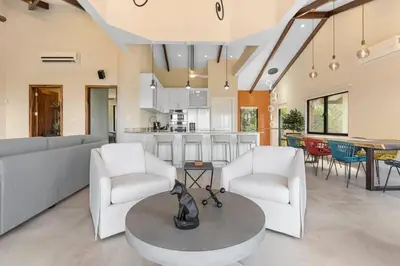 a living room with a couch and chairs and a table at Stylish Villa with Brand-New Furniture, Panoramic Ocean Views, and Infinity Swimming Pool & Hot Tub in Potrero