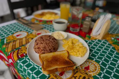 a plate of breakfast food with eggs and toast at Carey Lodging in Tortuguero