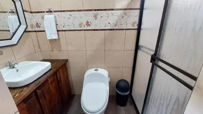 a small bathroom with a toilet and a sink at El Descanso Restaurante y Hotel in Fraijanes