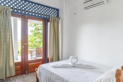 a bedroom with a bed and a sliding glass door at Mot Mot Vacation in Sámara