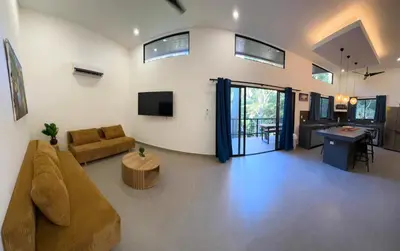 a living room with a couch and a table at Pinilla Highlands Incredible mountain views in Tamarindo