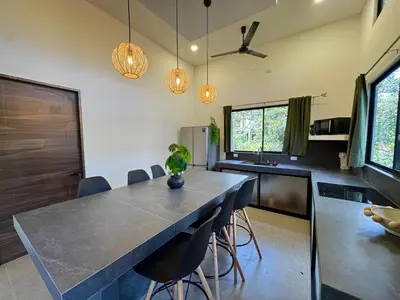 a kitchen with a large table and chairs at Pinilla Highlands Incredible mountain views in Tamarindo