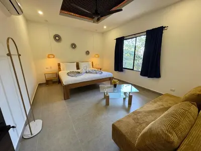 a living room with a bed and a couch at Pinilla Highlands Incredible mountain views in Tamarindo
