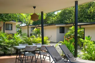 a patio with a white table and chairs at MY - Cosy Lodges in Paraíso