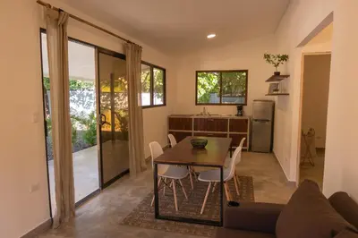 a kitchen and dining room with a table and chairs at MY - Cosy Lodges in Paraíso
