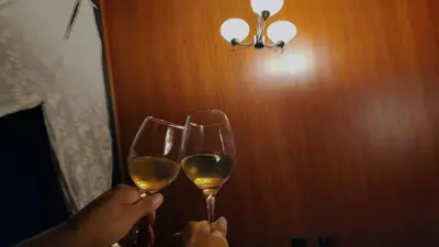 two people holding up glasses of white wine at Yarumo Lodge, Río Celeste Black Chalets in Bijagua