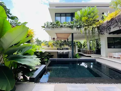 a villa with a swimming pool in front of a house at KUNUK- Walk to Hermosa beach in Santa Teresa Beach