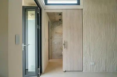 a hallway with a sliding glass door and a window at KUNUK- Walk to Hermosa beach in Santa Teresa Beach