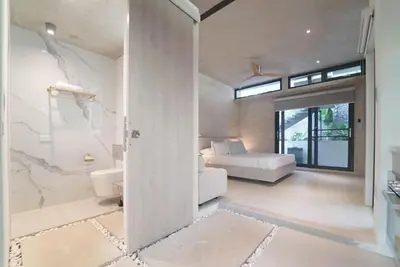 a room with a bedroom and a bed and a bathroom at KUNUK- Walk to Hermosa beach in Santa Teresa Beach