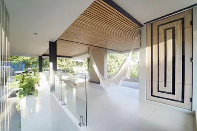 a living room with glass walls and a ceiling at KUNUK- Walk to Hermosa beach in Santa Teresa Beach