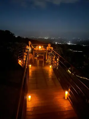 two women sitting at a table on a bridge with candles at Hotel Finca 360 in Marsella