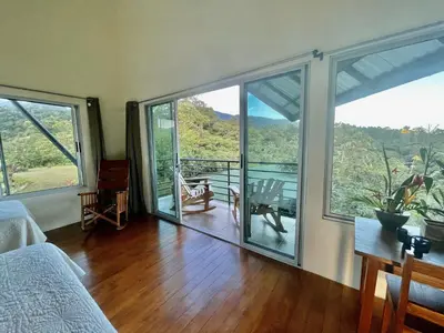 a bedroom with large windows and a wooden floor at Hotel Finca 360 in Marsella