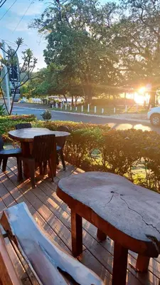 a group of picnic tables and benches on a deck at Hotel M&M Beach House in Coco
