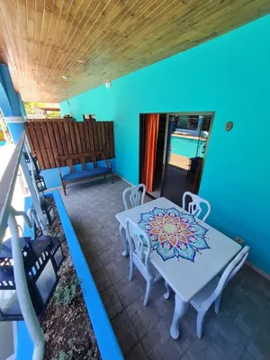 a dining room with a table and chairs on a balcony at Toro Blanco in Coco