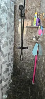 a bathroom with a shower with a pink towel at Very cozy beautifully designed loft apartment in Coco
