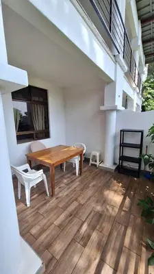 a room with a wooden table and a wooden floor at noemi apartments samara beach A-2 in Sámara