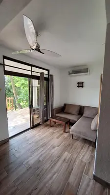 a living room with two couches and a ceiling fan at noemi apartments samara beach A-2 in Sámara