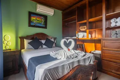 a bedroom with a bed with a heart on it at Kaluma Villas in San Ramón