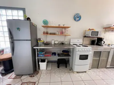 a kitchen with a refrigerator and a stove at Relax at Pier Sands Casita#1 - Close to the Beach! in Puntarenas