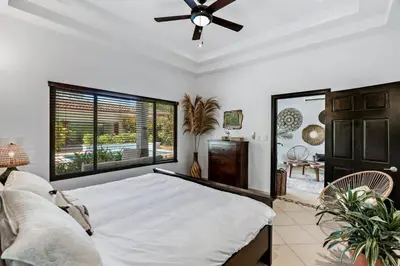 a bedroom with a bed and a ceiling fan at Stylish Home with Chic Decor, Luxury Amenities & Tropical Outdoor Oasis with Sparkling Private Pool in Brasilito