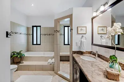 a bathroom with a tub and a toilet and a sink at Stylish Home with Chic Decor, Luxury Amenities & Tropical Outdoor Oasis with Sparkling Private Pool in Brasilito