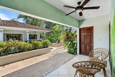 a house with a ceiling fan and a patio at Stylish Home with Chic Decor, Luxury Amenities & Tropical Outdoor Oasis with Sparkling Private Pool in Brasilito