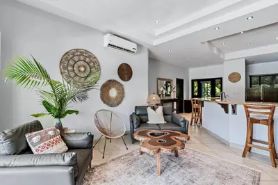 a living room with a couch and a table at Stylish Home with Chic Decor, Luxury Amenities & Tropical Outdoor Oasis with Sparkling Private Pool in Brasilito
