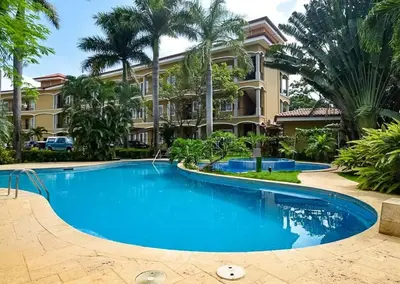 a large swimming pool in front of a building at 1 Bedroom with pool and walking distance to beach in Tamarindo