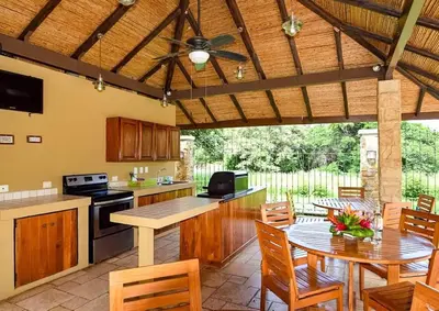 a large kitchen with a table and a ceiling fan at 1 Bedroom with pool and walking distance to beach in Tamarindo